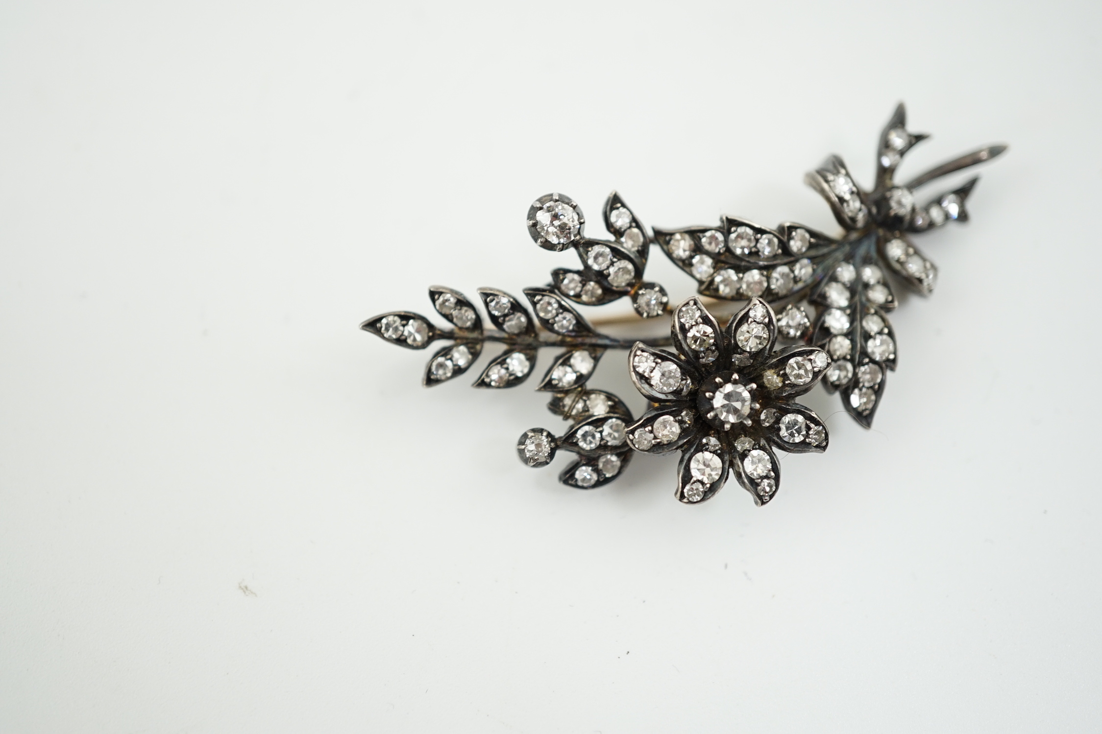 A late Victorian gold, silver and diamond cluster set trembleuse floral spray brooch
